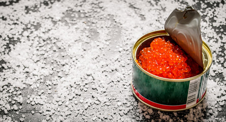 Red caviar in metal tin with salt.  Free space for text .