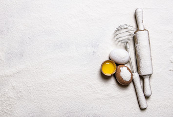 Eggs with venicom and rolling pin in flour.  Free space for text .