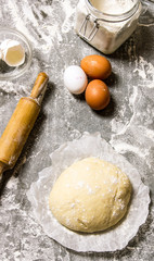 The dough with the ingredients and a rolling pin.