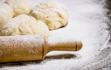 Preparation of the dough. The prepared dough with flour and with a rolling pin.