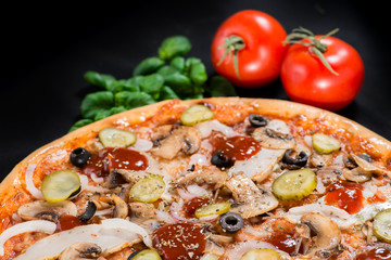 closeup Tasty pizza with tomatoes, mushroom, sausage, basil and