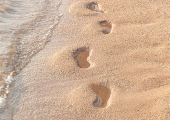 Detail of footprints on the sand beach..
