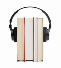 Headphones put on a few books