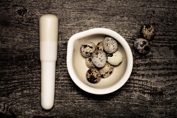 Composition with quail eggs. Wooden texture for background. Tone