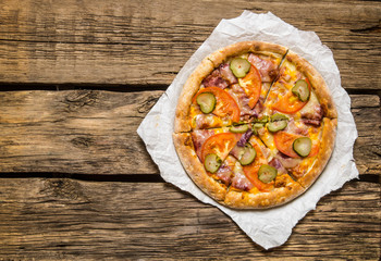 Fresh tasty pizza with tomatoes and ham.