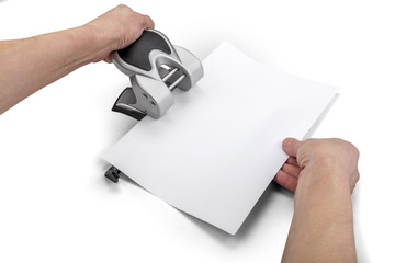 Office paper perforator and hands isolated on white with clippin