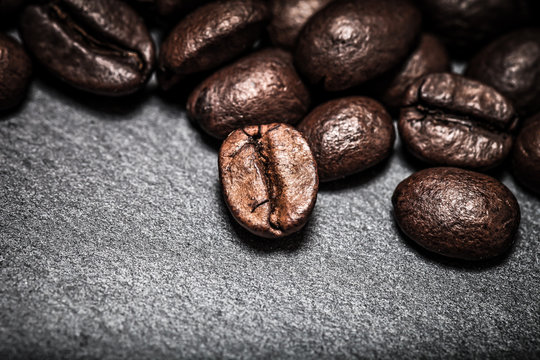 Coffee beans on the slate background. Toned