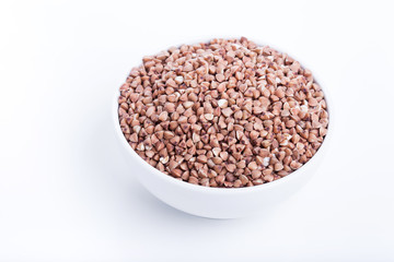 Dry buckwheat in white bowl