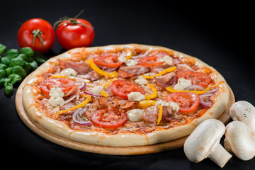 closeup Tasty pizza with tomatoes, mushroom, sausage, basil and