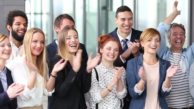 Portrait of happy business people clapping