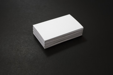 blank business cards stack up on Black background