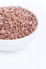 Dry buckwheat in white bowl