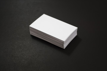 blank business cards stack up on Black background