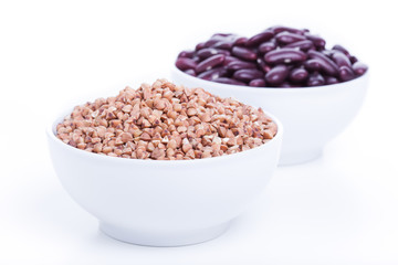 Dry buckwheat and black beans in white bowl