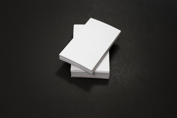 blank business cards stack up on Black background