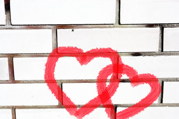 Two Hearts on White Brick Wall