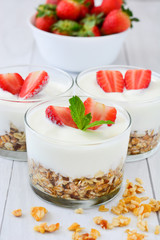 Yogurt glass with cereals and strawberries

