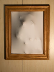 Creepy Picture Frame with Something Coming Out of It