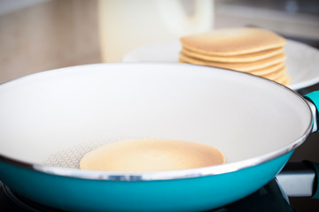 Fototapeta na wymiar Making home made pancakes on frying pan