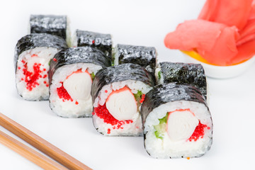 closeup sushi wrapped in nori with caviar and crab meat with cho