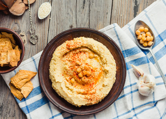 A bowl of creamy hummus with olive oil,garlic, paprika and pita