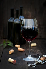 Glass of red wine on old wooden table