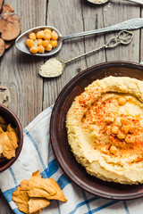 hummus of chickpeas, tahini paste and with paprika in a clay pla