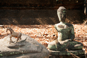 Fototapeta na wymiar Ancient outdoor broken Buddha in Wat Umong Suan Puthatham,Chieng Mai Province,Thailand.
