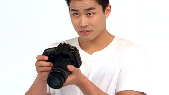Asian man taking picture with professional camera
