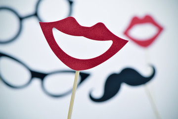 mouths, eyeglasses and mustaches on sticks, vignetted