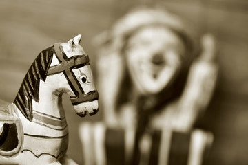 old wooden horse and old marionette, in sepia toning