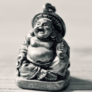 a laughing buddha in duotone