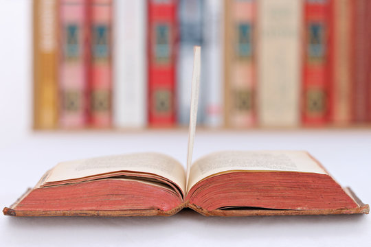close-up of a book on a table with a library in the background