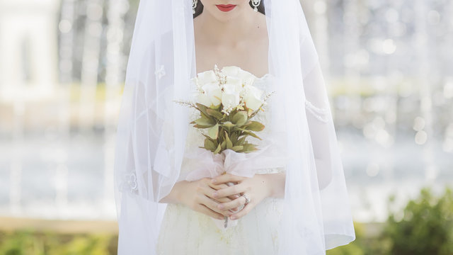 Bride holding flowers with smile.selecctive fucus at smile