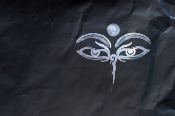 Hand drawn Eyes of Buddha on mauled paper