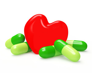 Red heart and herbal green pills on white. Prevention of heart disease.