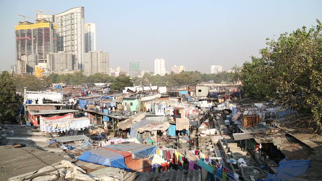 View of the slums in mumbai with highrise building in background