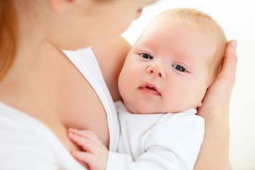 newborn baby in  arms of mother