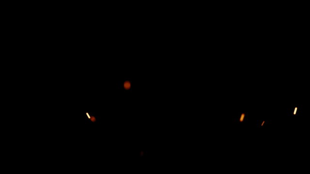 Rising Embers, Low Flames (25fps). Fire on low heat, hot burning embers rise up. The shallow focus makes the particles bokeh.
