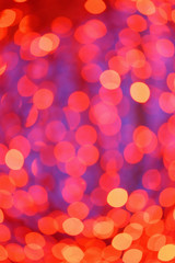 Defocused red lights during winter evening in city