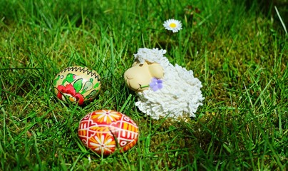 Easter Eggs with little sheep on a green grass