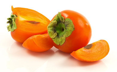 Group of ripe fresh persimmons with slices - 100747594