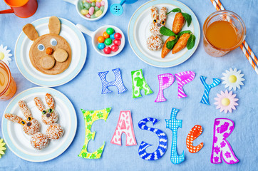 Happy Easter words with sweets and juice for kids