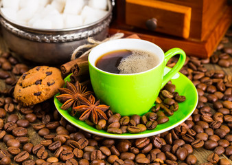 Coffee cup and saucer on a wooden table. Dark background, coffee
