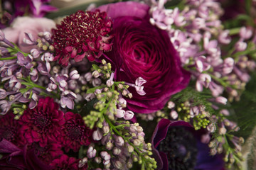 Beautiful close-up of a flower arrangement with purple and pink roses, peonies, anemones and lilac flowers