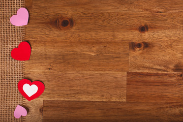 Paper hearts on wood background. Valentines Day decoration.