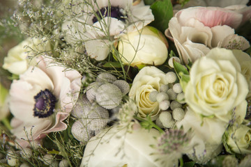 Close-up of a flower arrangement with white anemones, roses and peonies