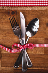 Valentines day set with silverware on wood background
