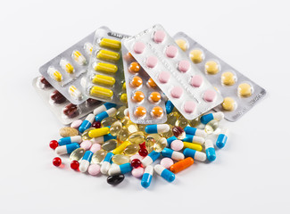Medications tablets and capsules in a beaker