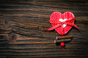 Red heart on an old wooden background